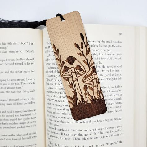 Add a touch of nature to your next novel with these beautiful eco-friendly wooden bookmarks. All bookmarks are engraved in-house using sustainably sourced American hardwood. After your new bookmark is engraved, it is finished with a black bookmark tassel. Best of all, this product is all-natural, so you can feel good about shopping small AND eco-friendly! Material: sustainable American hardwood, unfinished Sizing: 1.7 inch L x 5 inch W Thickness: 1/16 inch Black Bookmark, Scorch Marker, Bookmark Dimensions, Wood Burned Gifts, Mushroom Gifts, School Christmas Gifts, Beautiful Bookmarks, Wooden Bookmarks, Wood Decorations