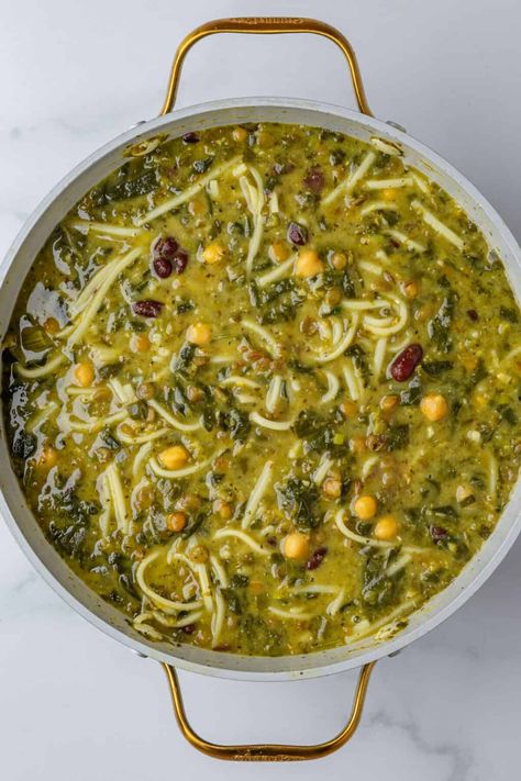 Ash Reshteh is a one pot Persian noodle soup filled with fresh herbs, leafy greens, and legumes. Eaten on Persian New Year, it comes straight to you from my childhood kitchen! Persian Soup, Ash Reshteh, Chickpeas Soup, Soup With Beans, Herb Soup, Persian New Year, Dried Lentils, Persian Cuisine, Iranian Food