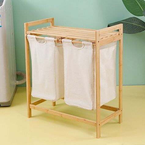 This laundry basket comes with a 2-tier table top, you can easily place your folded clothes, and it also helps you store other essentials such as detergent and softener in a convenient place. Wood Laundry Hamper, Laundry Sorter, Bath Organization, Dark Clothes, Clothes Hamper, Laundry Bags, Hamper Basket, Bathroom Storage Organization, Bamboo Frame