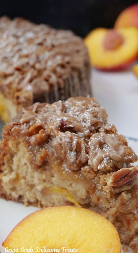 A slice of peach coffee cake on a white plate with peaches cut in half in the background. Peach Coffee Cake, Pecan Streusel Topping, Peach Coffee, Classic Coffee Cake, Pecan Coffee Cake, Breakfast Coffee Cake, Cinnamon Glaze, Coffee Cake Recipes Easy, Streusel Cake