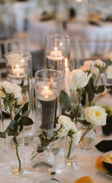 Bud vases and candle centerpieces Centerpieces With Bud Vases, Rustic Chic Wedding Centerpieces, Bud Vases Candles, Candle Water Centerpiece, Chic Wedding Centerpieces, White Rose Centerpieces, Wedding Centerpeices, Bud Vases Wedding, Bud Vase Centerpiece