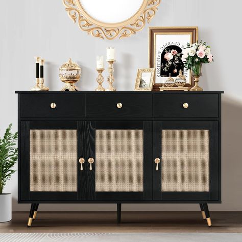 PRICES MAY VARY. PLENTY OF STORAGE SPACE: You can easily organize your items with this buffet. This 3-door buffet comes with a large capacity and is clearly divided into functional sections. You can organize books, clothes, blankets, and even kitchen supplies. Our buffet can help you solve the problem of clutter in your home! BLACK AND GOLD DECORATION: Our decorative cabinet consists of handcrafted rattan doors, black woodgrain and gold hardware knobs and woodgrain drawers for a touch of eleganc Rattan Buffet, Black Sideboard Buffet, Sideboard Sliding Doors, Unique Sideboard, Rattan Cabinet, Rattan Doors, Black Buffet, Shelves For Living Room, Rattan Sideboard