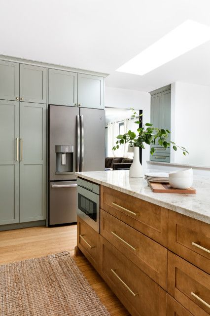 Soft Green Cabinets, Warm Wood Kitchen Cabinets, Light Brown Kitchen Cabinets, Light Brown Kitchen, Warm Wood Kitchen, Green Kitchen Island, Light Wood Kitchens, Brown Kitchen Cabinets, Light Wood Cabinets