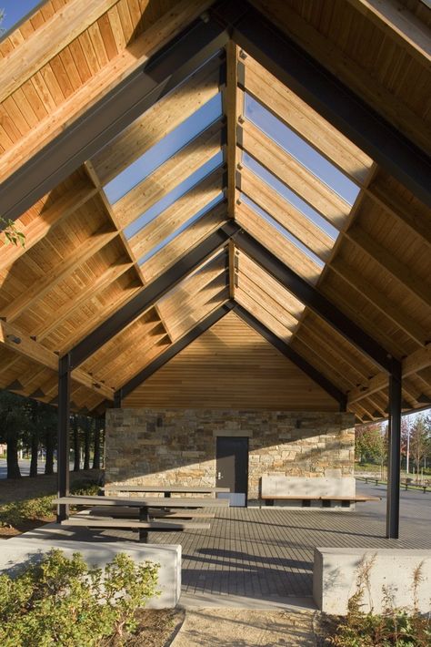 For the award-winning Wilsonville Memorial Park, Hennebery Eddy designed three new park structures and rehabilitated a historic barn for use as an event space. The picnic shelters and restrooms convey a sense of permanence and quality while complementing the park’s natural areas. They feature simple but gracious gable-roofed structures, well-crafted natural stone, clear finished wood … Wood Roof Structure, Gable Roof Design, Australia House, Interior Ceiling Design, Shelter Design, Pavilion Design, Wood Roof, Wood Building, Roof Architecture