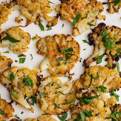 This Garlic Parmesan Smashed Cauliflower is a delicious healthy side dish. It is easy to make and goes with any protein. Smashed Cauliflower Bites, Smashed Cauliflower Recipes, Smashed Cauliflower, Parmesan Cauliflower, Roasted Cauliflower Recipes, Healthy Side Dish, Cauliflower Cheese, Cauliflower Bites, Baked Cauliflower