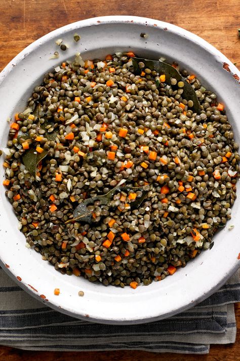 NYT Cooking: This is a classic French way to cook lentils, and it’s very easy. Aromatics are sautéed and then simmered with French lentils, also known as Le Puy lentils, for 20 to 25 minutes. It is an easy side dish (shown here with <a href="http://cooking.nytimes.com/recipes/8174-cod-baked-with-prosciutto">cod baked with prosciutto</a>), redolent of a Provencal feast. Green Lentil Recipes, Cook Lentils, Puy Lentils, Lentils Recipe, French Green Lentils, Thyme Recipes, French Lentils, French Green, How To Cook Beans