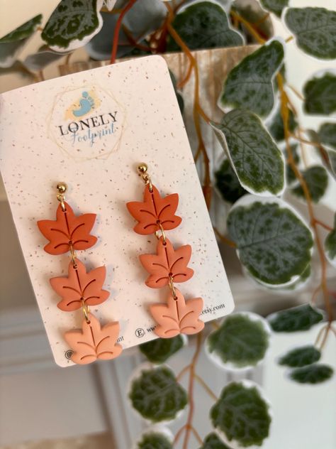 Handmade polymer clay maple leaf dangle earrings in warm autumn shades. Lightweight and nature-inspired, these earrings are perfect for adding a touch of autumn to your outfits. Ideal as a unique gift or everyday accessory. These earrings are carefully handmade using polymer clay and gold plated studs. All earring posts, studs and hoops are lead and nickel free. All earrings are handmade, therefore each design will be unique.  Please note there may be slight variations/imperfections, although I Autumn Leaf, Earrings Polymer Clay, Earring Posts, Fall Jewelry, Warm Autumn, Leaf Earrings, Handmade Polymer Clay, Clay Jewelry, Maple Leaf