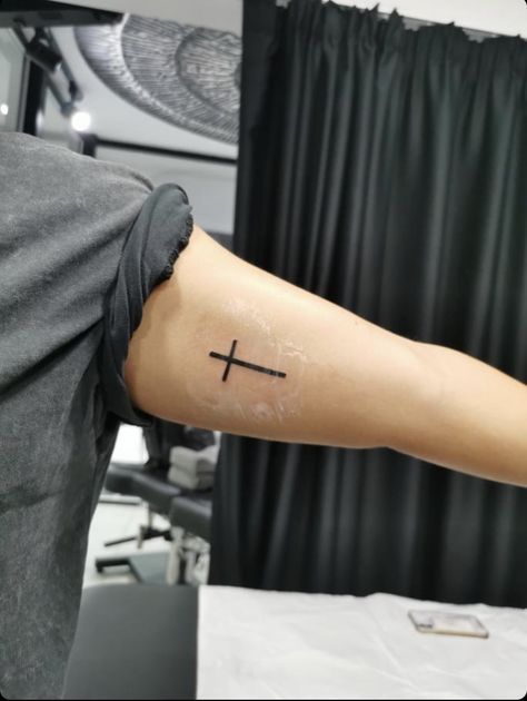 Cross tattoo simple black ink Bicep Cross Tattoo, Inner Bicep Tattoo Men, Simple Cross Tattoo, Bicep Tattoo Men, Inner Bicep Tattoo, Tatted Men, Christ Tattoo, Simple Tattoos For Guys, Cross Tattoos