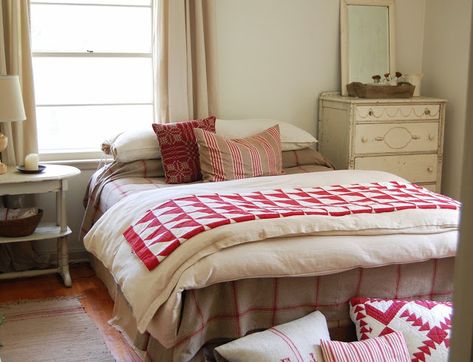 It's OK to put a bed in front of a window, even if it's off-center. In this example, the window is balanced by the tall dresser on the other side. Besides, with such pretty linens, who's looking at anything else? Off Center Windows, Happy Bedroom, Traditional Bedside Tables, Red And White Quilts, Bedroom Windows, Down Comforter, Parade Of Homes, Bedroom Layouts, Cozy Place