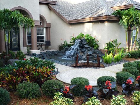 A robust water feature and colorful plantings welcome visitors to this home. Posted by landrock.Share This Photo Gallery  Facebook Twitter Link to this Photo Gallery: Yard Bridge, Front Yard Designs, Front Yards Diy, Small Front Yards, Landscape Design Small, Florida Landscaping, Tanaman Indoor, Small Front Yard Landscaping, Small Front Yard