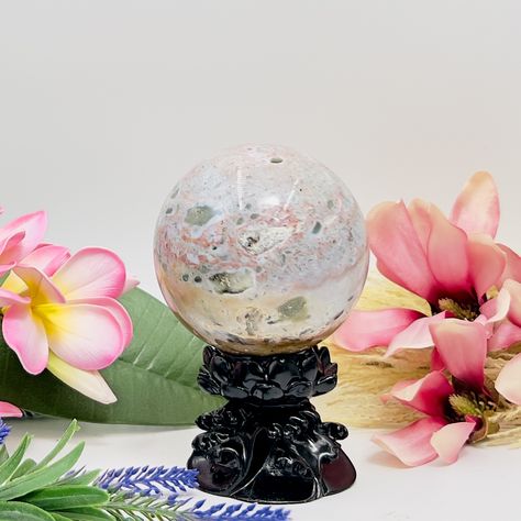 Ocean Jasper Sphere Healing Crystal Ball 1047g 91mm https://www.malaand.me/products/ocean-jasper-sphere-healing-crystal-ball-1047g-91mm Ocean Jasper, also known as Orbicular Jasper or Sea Jasper, is a distinctive and highly sought-after variety of Jasper that is known for its unique orbicular patterns, swirling colors, and spherical inclusions. This fascinating gemstone exhibits a wide range of colors, including shades of green, pink, red, orange, yellow, cream, and white, often mixed toget... Sea Jasper, Orbicular Jasper, Red Orange Yellow, Yellow Cream, Crystal Sphere, Ocean Jasper, Large Crystals, Crystal Shop, Healing Crystal