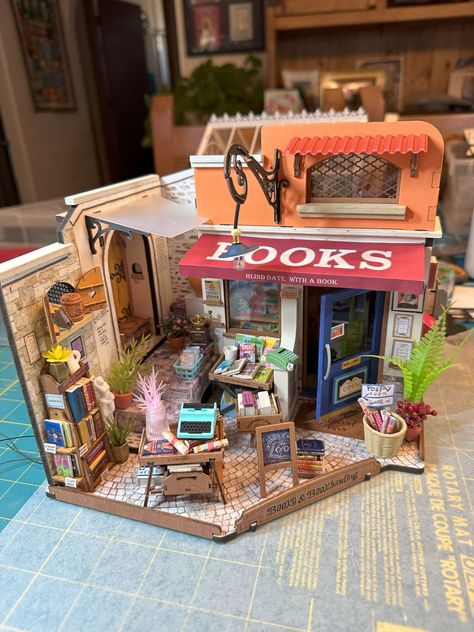 I had so much fun making this miniature bookstore. Martin helped me with the lighting again. 😁  I think my favorites so far are the garden house and this bookstore. I am absolutely obsessed with making miniature houses! I work on them mostly in the early morning. One of my dogs is very old and gets me up at 4 a.m., so I have plenty of time to enjoy my new hobby. 😁 

#miniaturehouses #rolife #minibookstore #earlymorningcrafting #tinyworlds #miniatures #writerscommunity #authorlife #writerlife Rolife Miniature, Miniature Bookstore, Mini Bookstore, Xmas Village, Film Ideas, Computer Projects, Miniature Things, Toy Display, Little Library