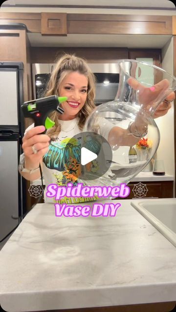 Amanda Jean Gilmore on Instagram: "Transforming my home into a haunted haven with this DIY spiderweb vase that lights up! 🕷️✨ Perfect for adding a touch of spooky elegance to any room. Who says Halloween has to wait until October? 👻🕸️ I got all my supplies at @Dollar Tree  and @Walmart and my shirt is from @Five Below happy#Summerween #DIYMagic #SpookyVibes #LightUpCraft #CreepyDecor #CraftingFun #SpookySeason #HauntedVibes #HalloweenAllYear 🎃 💀 #SpookySeason #DIYCrafts #HauntedHouse #DollarTreeFinds #HalloweenDecor #CraftingFun #GetCrafty #dollartreediy #dollartree #craft #halloweencrafts #diys #happycrafting #dollartreefinds #SpookySeason #dollartree #halloween2024countdown #walmartcrafts" Purple And Black Centerpieces Diy, Diy Halloween Vase Ideas, Simple Halloween Centerpieces For Table, Dollar Tree Halloween 2024, Diy Halloween Decorations For Inside Home Decor, Diy Halloween Vase, Halloween Vase Ideas, Dollar Tree Halloween Diy 2024, Dollartree Halloween Decor Diy