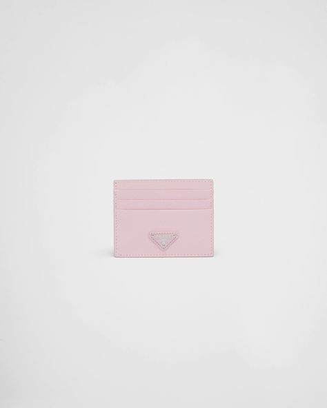 The unmistakable texture of Saffiano leather characterizes this sleek card holder. The accessory with six card slots is decorated with a tonal enameled metal triangle logo. Cute Card Holder Wallet, Prada Card Holder, Feminine Esthetics, Pink Prada Bag, Designer Wallets For Women, Pink Card Holder, Luxury Card Holder, Designer Card Holder, Funky Purses