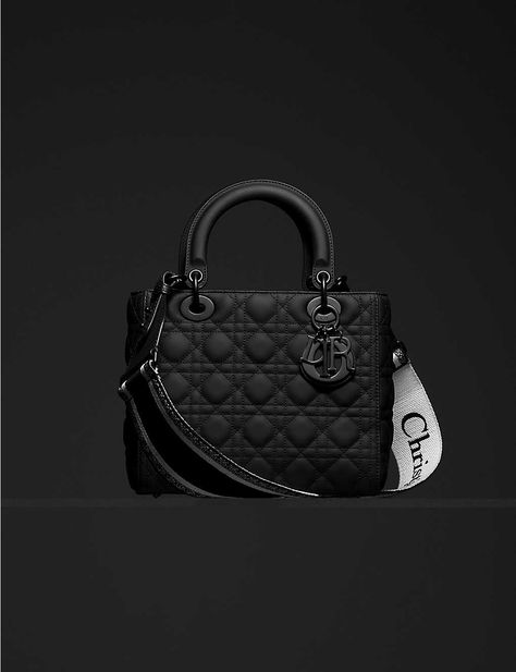 An icon can come in a variety of shapes and sizes. In the case of the Lady Dior handbag by Dior, it’s rendered in supple leather. Neatly crafted in Italy to a boxy silhouette, the piece is embroidered with Cannage stitching across its four sides and fitted with a removable strap stamped with its maker’s name. Swinging from one of the two top handles, charms shaped to mimic the letters of the French house’s moniker subtly contrast against the dark fabric. (Height 24cm, width 20cm, depth 11cm) Thi Dior Designs, Lady Dior Handbag, Fancy Bags, Dior Fashion, Dior Handbags, Modieuze Outfits, Mode Inspo, 가을 패션, Handbags Online