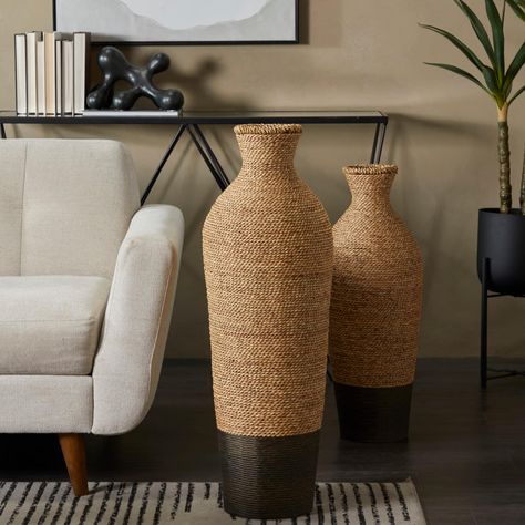 "Buy the Brown Seagrass Handmade Tall Woven Floor Vase at Michaels. com. A boho inspired style that exudes creative form with a free-spirited design. This brown round vase is made of seagrass, iron, and polyethylene materials for robust structure. A boho inspired style that exudes creative form with a free-spirited design. This brown round vase is made of seagrass, iron, and polyethylene materials for robust structure. It features a two-tone color trend with a light natural brown top section and Pampas Grass Vase, Farmhouse Vase, Tall Floor Vases, Dried Pampas, Flower Vases Decoration, Colored Vases, Living Room Area, Round Vase, Tall Vases