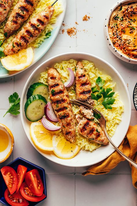 Chicken kofta kebabs cut open with a fork over a bowl of lemon rice Chicken Kofta Recipe, Chicken Kofta, Kofta Recipe, Veggie Skewers, Ww Freestyle, Grilled Teriyaki Chicken, Middle Eastern Dishes, Lemon Rice, Minimalist Baker