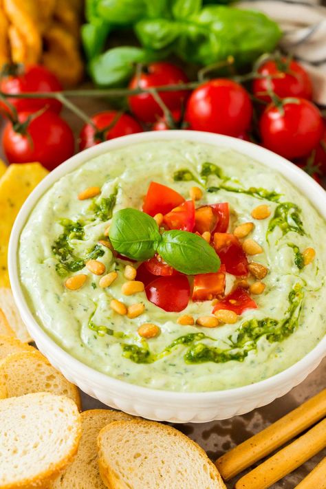 This pesto dip is a blend of mayonnaise, sour cream, basil pesto and seasonings that are combined to create a rich and creamy dip in just minutes. The easiest last minute appetizer option that pairs well with bread, veggies or can even be used on a sandwich or as a salad dressing. Pesto Appetizers, Pesto Dip, Thanksgiving Appetizer Recipes, Bacon Deviled Eggs, Christmas Recipes Appetizers, Creamy Pesto, Creamy Dip, Quick And Easy Appetizers, Best Appetizer Recipes