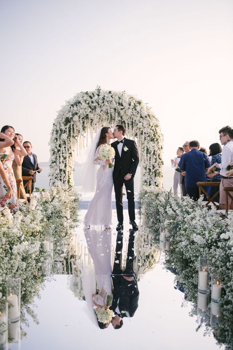 There are almost no words to describe this incredible destination wedding in Phuket. With a mirror walkway ending at a stunning white floral arch surrounded by the sea...these photos are out of this world! Reflective Walkway Wedding, Wedding Aisle Mirror, Mirrored Walkway Wedding, Mirror Pathway Wedding, All White Wedding Ceremony Decor, Mirror Isle Runner Wedding, Mirror Isle For Wedding, White Flower Decoration Wedding, Beach Wedding Walkway