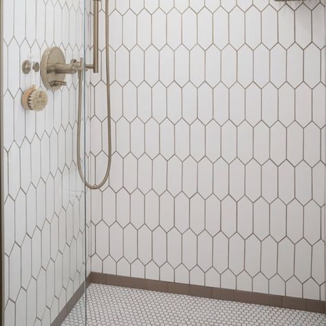 Recreate this fabulous shower for your new bathroom remodel.  It's comprised of three patterns and the brown subway it the frame where the elongated hex tile meets the penny round tile.   Please see the carousel for closeups of the three tile design that make up this shower.  
This shower inspiration is part of the Bathroom in a Box Crewe Design Collection.  The rest of the products to complete the bathroom remodel are shown with links on where to purchase. Penny Stone Tile Bathroom, Penny Tile In Bathroom, Penny Round Bathroom Floor, Penny Round Tile Bathroom Floor, Picket Tile Bathroom, Penny Round Tile Bathroom, Tile In Bathroom, Penny Tiles Bathroom, Picket Tile