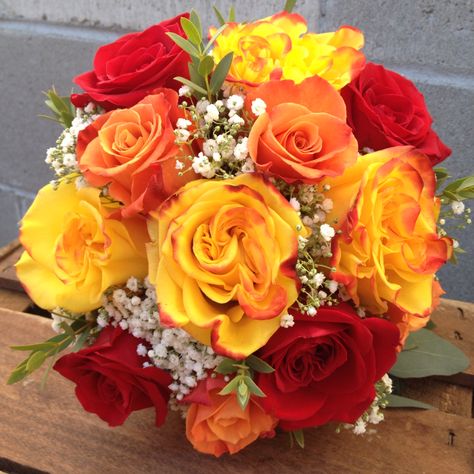 Red, yellow, and orange roses arranged in a bridal bouquet. Simple, colorful, and classy for a fall ceremony. Orange And Red Roses Bouquet, Red Orange And Yellow Flowers, Yellow And Orange Roses Bouquet, Orange And Yellow Wedding Flowers, Mcdonalds Wedding, Quinceañera Planning, Yellow Rose Wedding, Orange Rose Bouquet, Rose Bouquet Wedding