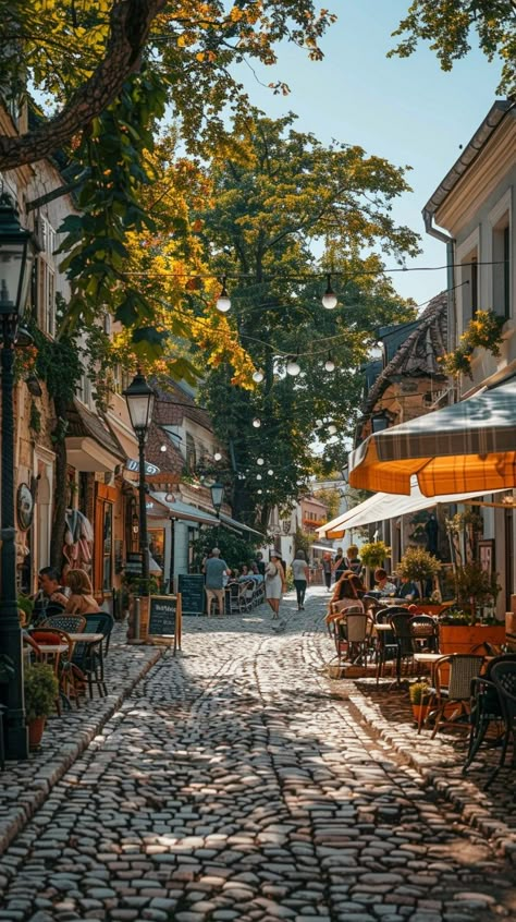 Cobbled Street Charm: Quaint #cobblestone street bustling with activity as people enjoy #outdoor #dining under the shade of #trees. #aiart #aiphoto #stockcake ⬇️ Download and 📝 Prompt 👉 https://stockcake.com/i/cobbled-street-charm_762832_1015428 Paris Cobblestone Streets, Cobble Stone Streets, Cobblestone Streets Aesthetic, Paris Street Cafe, Beach Rain, Dream Cafe, Cobblestone Street, Sidewalk Cafe, Stone Street