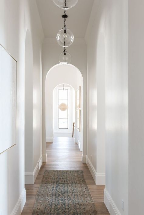 Left side mirrors down hallway hanging globes from entry to kitchen Upstairs Hallway Lighting, Long Hallway Lighting Ideas, Studio Mcgee Hallway, Hallway Lights Ideas, High Ceiling Hallway, Hallway Pendants, Entry To Kitchen, Studio Mcgee Lighting, Hallway To Kitchen