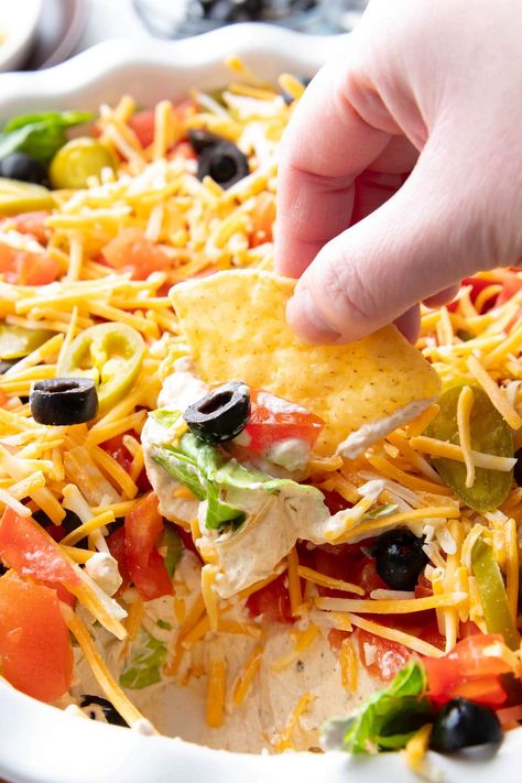 The only Taco Dip you’ll ever need—a thick layer of taco seasoned cream cheese & sour cream topped with crisp lettuce, diced tomatoes, olives, spicy jalapeños and cheddar cheese. Like the best taco in dip form! | Recipe at BeamingBaker.com Simple Taco Dip, Mexican Layer Dip Recipe, Cold Taco Dip, Cream Cheese Salsa Dip, Taco Dip With Cream Cheese, Easy Taco Dip, Bean Dips, Cream Cheese Taco Dip, Taco Dip Easy