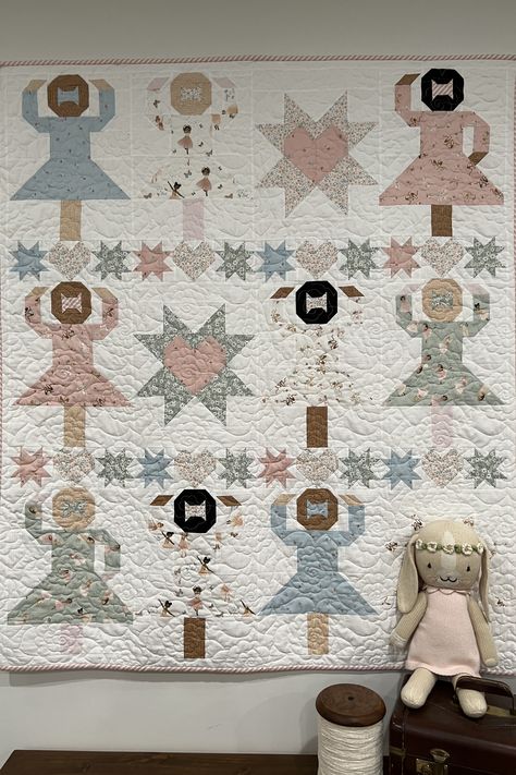 Do you have a special little one who loves to spin and twirl? Celebrate the "twinkle toes" in your life with our "Ballerinas" quilt pattern. Finishing at 50" x 58", this whimsical and charming quilt is perfect for children who dream of leaping, twirling, and pirouetting like graceful ballerinas. It features the fabric line "Return of the Jete" by Dear Stella Fabrics. #Keepsakequilt #CoachHouseDesigns #DearStellaFabrics #Ballerinas #BallerinaQuilt #DanceQuilt #Quilting Ballerina Quilt Ideas, Ballerina Blanket, Ballerina Quilt, Ballet Quilt, Dear Stella Fabric, Keepsake Quilting, Twinkle Toes, Coach House, Square Quilt