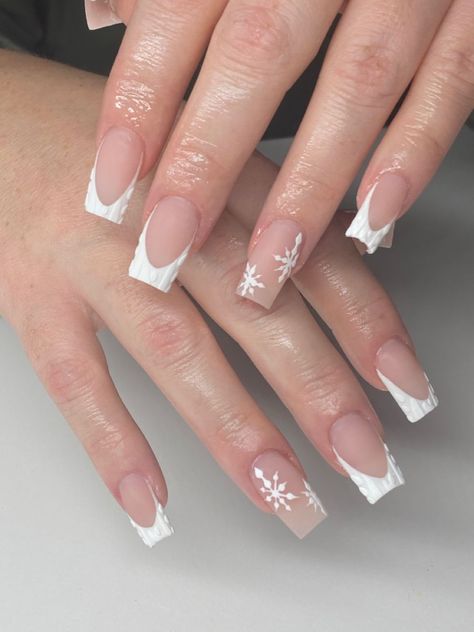 It can be anything, as long as it's holiday-themed! Winter Christmas Nails French Tip, White Christmas Nails French Tips, Simple Nail Christmas Designs, French Tip And Snowflake Nails, White French Tip With Snowflake On Ring Finger, French Tip Acrylic Nails With Snowflake, White French Tip Sweater Nails, Short French Tip Acrylic Nails Christmas, Pink French Tip Christmas Nails