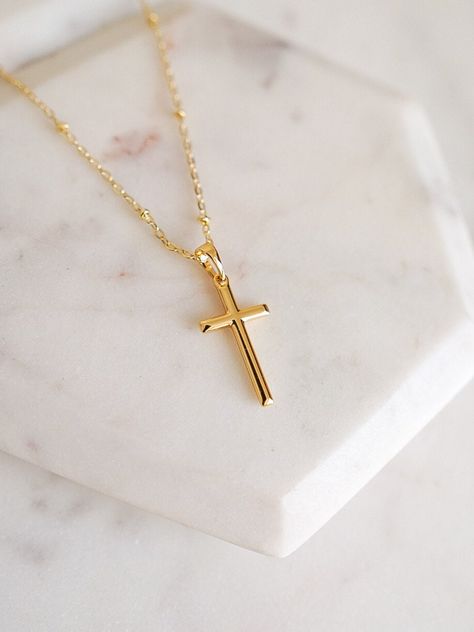 Our simple gold cross necklace is designed with a small gold cross pendant hanging from a delicate gold satellite chain. This dainty gold necklace is perfect for layering and would make the perfect gift for any religious occasion such as baptism, first communion, confirmation or birthday.  DETAILS:   - 14k gold filled dainty satellite chain 17 inches w. 2 inch extender  - 14k gold filled small gold cross pendant 1 inch length  - Handcrafted with love and good vibes in Miami, FL  - Pre-packaged f Gold Necklace Cross, Birthday Details, Cross Necklace Gold, Cross Charm Necklace, Schmuck Gold, Faith Necklace, Gold Cross Necklace, Gold Cross Pendant, Dainty Gold Necklace