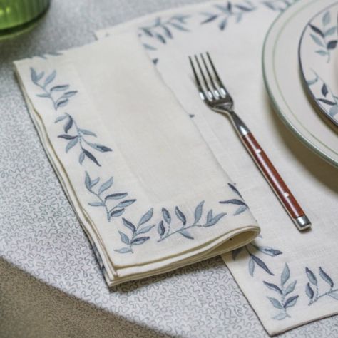 These exquisite napkins are embroidered with a detailed foliage design around the border. Available in three pastel colours, they are perfect for both formal and informal dining occasions. Dimensions: 50cm x 50cm FEATURES: 100% Linen Hand embroidered by artisans in India Designed exclusively by Birdie and her team in Norfolk Truly unique: produced in small batches Available in red, blue and green Hand wash at 30 degrees celsius Luxury Napkin, Embroidery Napkins, Blue Foliage, Soft Summer Colors, Blue Napkins, Summer Colours, India Design, Embroidered Napkins, Border Embroidery