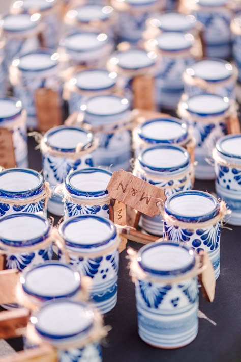 Blue and white talavera shot glasses pictured with the bride and groom's initials tagged. Wedding Favors For Guests Mexican, Mexico Wedding Party Favors, Wedding Favors Mexican, Blue And White Talavera Wedding, Blue Talavera Wedding, Mexican Wedding Party Favors, Colombian Wedding Ideas, Mexico Wedding Favors, Mexican Glamour