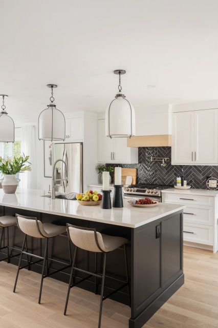 Bellefeuille House - Transitional - Kitchen - Montreal - by Laurie Yapp Design | Houzz Kitchen Island Grey Countertop, Kitchen With Black Island White Cabinets, Kitchen Island Trim Ideas Modern, Kitchen Island Black Countertops, Black Kitchen Island White Cabinets, White Kitchen Dark Island, Iron Ore Kitchen Island, Dark Gray Island, Large Island Lighting