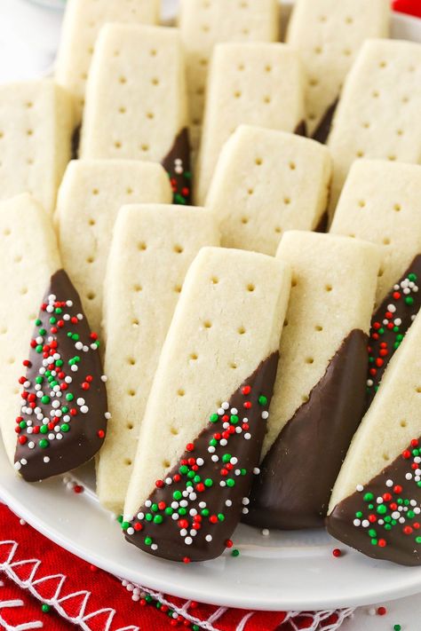 These Easy Shortbread Cookies are crispy on the outside and soft on the inside with that classic sweet and buttery flavor. Sprinkled with sugar and dipped in chocolate, they make an excellent addition to your holiday cookie tray! Candy Cane Cookie Recipe, Xmas Cookies Recipes, Easy Gingerbread Cookies, Favorite Christmas Desserts, Cookies Shortbread, Chocolate Dipped Cookies, Christmas Shortbread, Best Christmas Cookie Recipe, Cookie Sticks