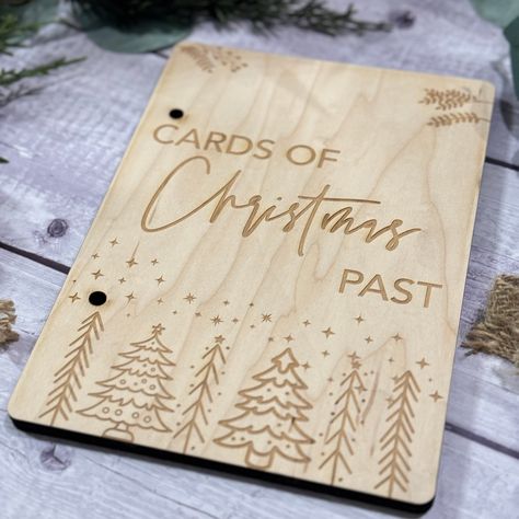 "Cards of Christmas Past Preserve the magic of the holiday season with this charming keepsake designed to hold all your Christmas cards, providing a nostalgic glimpse into the festive moments of years gone by. Crafted from 1/8 inch plywood and equipped with two 2-inch binder rings, it ensures a secure place for your cherished letters and cards. Comes with 2\" binder rings to hold your letters/cards. Dimensions: 6 inches x 8 inches Hole spacing: 4.5 inches apart Return Policy: Please note that al Cards Of Christmas Past, Card Keeper, Gift Card Presentation, Laser Crafts, Glow Forge, Laser Cut Wood Crafts, Binder Rings, Laser Engraved Ideas, Laser Ideas