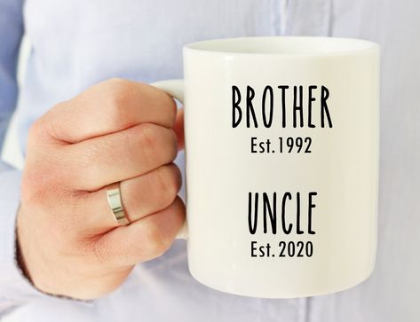 "Custom Brother to Uncle Mug,Custom New Uncle Mug,Uncle Gift,Uncle Coffee Mug,New Uncle,Pregnancy Announcement,New Uncle Gift,New Baby Mug, Gift for Uncles CUSTOMIZABLE MUG DETAILS: ♥ 11 or 15 oz white ceramic mug (select capacity) ♥ Images are printed on both sides ♥Dishwasher and microwave safe TO CUSTOMIZE YOUR MUG: Please type your custom details (Est Year) in the personalization box above the „Add to cart\" button, then add the mug to your cart.  See more funny mugs for uncle and family: ht Uncle Pregnancy Announcement, Uncle Mug, Friends Tv Show Gifts, Baby Shadow Box, Phd Graduation Gifts, Cute Pregnancy Announcement, Baby Announcement Pictures, Pregnancy Announcement Gifts, Gifts For Uncle