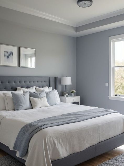 Create a soothing atmosphere with a blue-gray accent wall in your bedroom. Complement it with crisp white bedding, a mirror with a wooden frame, and a soft gray area rug for a modern and elegant look. Gray Accent Wall Bedroom, Bedroom Wall Colour Combination, Gray Accent Wall, Grey Colour Scheme Bedroom, Comfortable Bedroom Decor, Beautiful Bedroom Colors, Blue Bedroom Walls, Best Bedroom Colors, Wall Color Combination