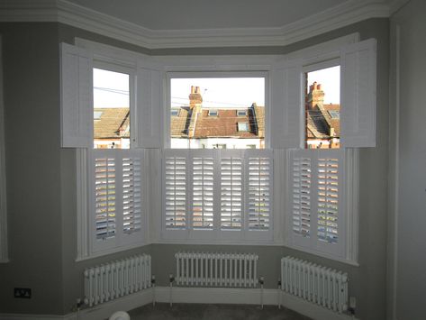 Should I choose window shutters, curtains or blinds? Bay Window With Shutters, White Shutters Bay Window, Bay Window Radiator Ideas, Edwardian Radiators, Plantain Shutters, Shutters For Bay Windows, Bay Window Radiator, Shutters Bay Window, Window Radiator