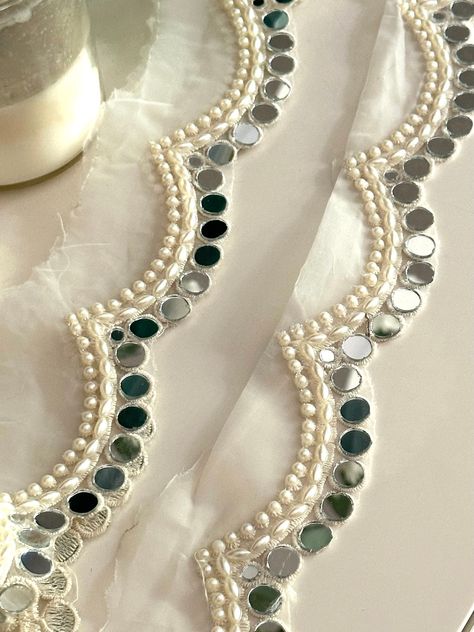 2.5cm Elegant White Pearl and Mirror Scalloped Trim - Indian Ribbon for DIY Sewing, Crafting, Dupatta Neck, Drapery, Lampshade Lace by Yard Enhance your projects with this stunning 2.5cm Elegant White Pearl and Mirror Scalloped Trim. Perfect for adding a touch of sophistication to dupattas, necklines, and drapery, this Indian ribbon is ideal for various crafting applications ✨. Materials: Pearls Mirror Accents Durable Lace Fabric Uses: DIY Sewing: Perfect for embellishing garments. Dupatta Neckl Mirror Work On Dupatta, Mirror Design Dress, Mirror Suit Design, Duppattas Designs Ideas With Lace, Pearl Dupatta, Pearl Mirror, White Sari, Hand Beaded Embroidery, Diy Tassel