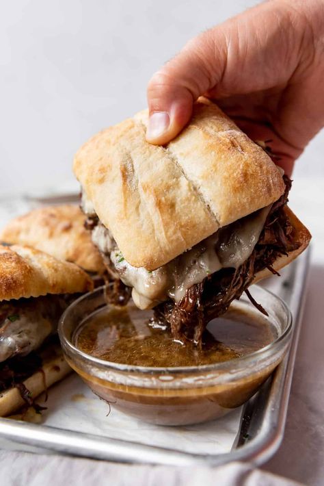 These toasty Slow Cooker French Dip Sandwiches are made with slow cooked roast beef served on crusty rolls with melty cheese and savory au jus. The prep is less than 15 minutes and then the crockpot does all the work for you. This slow cooker french dip sandwhich recipe is so good! | french dip sandwich crockpot | french dip sandwich instapot | french dip sandwich instant pot | french dip sandwich easy roast beef | french dip sandwich easy crock pot Slow Cooked Roast Beef, Slow Cooker French Dip Sandwiches, Slow Cooker French Dip, French Dip Sandwiches, Dip Sandwiches, French Dip Sandwich, French Dip, Chapati, Beef Stew