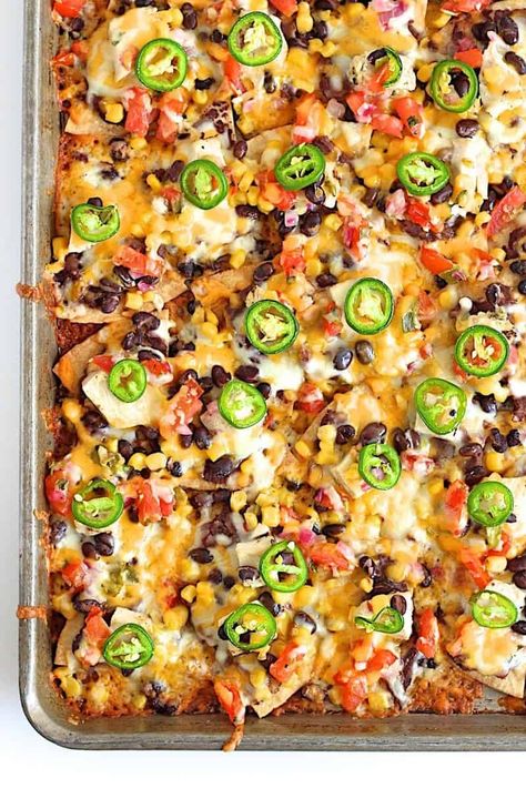 Sheet Pan Chicken and Black Bean Nachos Black Bean Nachos, Nachos Loaded, Bean Nachos, Nachos Recipe Easy, Easy Sheet Pan Dinners, Loaded Nachos, Sheet Pan Suppers, Sheet Pan Dinners Recipes, Sheet Pan Chicken