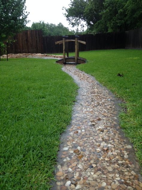 My backyard during heavy rain has extra water flowing from higher lots behind us. After moving in to almost zero grass I could see a problem with excessive standing water between my home and neighbor. I just built a dry creek bed with a catch. Much of the yard has limestone just beneath the surface so during heavy rain we have a creek. Storm Water Runoff Solutions, Creek Ideas Natural, Backyard Water Runoff Ideas, Diy Backyard Creek, Lowcountry Landscape Ideas, Wet Yard Solutions Backyards, Zero Lot Line Landscaping, Rain Scaping Ideas, Rain Scaping