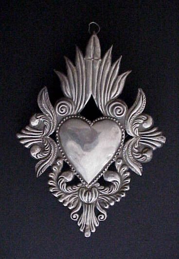 Vintage Sacred Heart Milagro, Ex Voto | This is a beautiful old South American sterling silver milagro, or ex voto from the early part of the 20th century. | The ex voto was left in a church in Peru by a pilgram or devotee giving thanks for his or her wish fulfilled. This large milagro, formed from one sheet of silver, is in the shape of the sacred heart and decorated with traditional Spanish colonial foliate designs in deep repoussé. Tattoo Heart, Metal Embossing, Tin Art, I Love Heart, My Funny Valentine, Mexican Art, Mexican Folk Art, Heart Art, Heart Tattoo