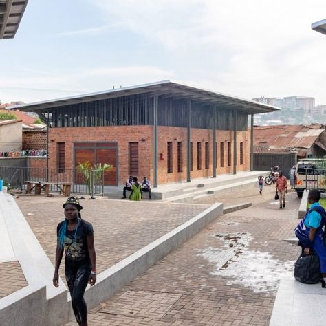 Steel canopies shade the spaces of the Kamwokya Community Centre in Kampala, Uganda, designed by Berlin studio Kéré Architecture. Community Space Design, Sustainable Schools, Community Places, Butterfly Roof, Canopy Architecture, Kampala Uganda, Community Halls, Community Centre, Earth Homes