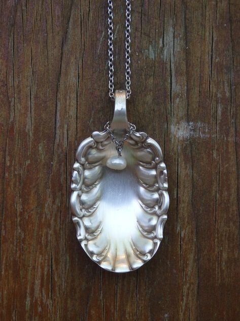 I created this unique necklace using an antique silver-plate sugar spoon I found at a antique shop I love taking antique silverware and giving it new life. This scalloped sugar spoon is truly beautiful and creates lovely one of a kind jewelry A fresh water pearl dangles in front of the spoon pendant Cutlery Crafts, Vintage Spoon Jewelry, Flatware Crafts, Sterling Silverware, Spoon Pendant, Silver Spoon Jewelry, Silverware Crafts, Fork Jewelry, Flatware Jewelry