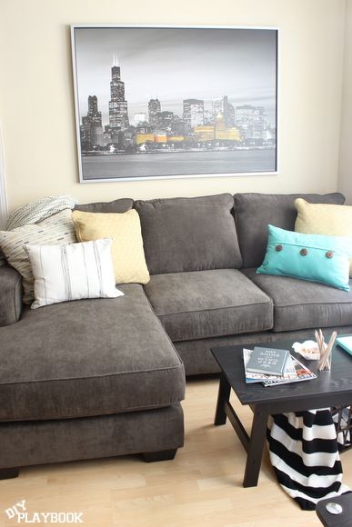 Dark gray couch with yellow and blue accents Dark Gray Couch, Grey Carpet Living Room, Gray Couch, Grey Couch, Grey Couch Living Room, Simple Pop, Spring Yellow, Diy Playbook, Blue Living Room