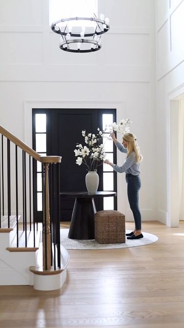 Interior Design | Real Estate on Instagram: "I love a round table in the middle of a foyer … see more of our home on my personal page @katerumson Round table: @sherrillfurniturebrands Faux magnolia branches: @elevengardens #SherrillPartner #newhome #foyerdesign #twostoryfoyer #newbuild #newconstruction #newjersey" Table In Foyer Entry Ways, Foyer Circle Table, Circle Table Entryway, Square Foyer Entryway, Foyer With Round Table, Round Table Foyer, Round Entry Table Decor, Round Foyer Table Decor Entryway, Round Foyer Table Decor