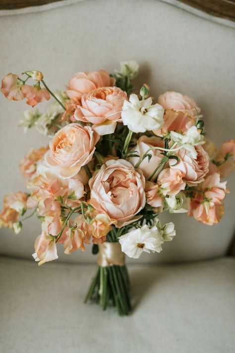 A bouquet adorned with delicate peachy and pink hues, embodying the essence of romance and love's beauty. 💐💖 Each petal tells a story of elegance and grace. #RomanticBouquet #PeachyPinkTouches #WeddingFloralArtistry #Flowers #Bridesbouquet #Love #Makehappymemories #destinationwedding Peachy Pink Wedding Bouquet, Peach And Pink Bridal Bouquet, Champagne And Peach Bouquet, Spring Wedding Flowers Peonies, Light Peach Ivory Wedding, Apricot Flower Arrangements, Peach Peony Wedding Bouquet, Peach And Blush Bouquet, Beach Wedding Peach Colors