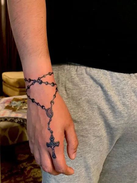 Rosary Around Wrist Tattoo, Rosery Beads Tattoo, Rosary Tattoo Ideas, Rosary Ankle Tattoos, Rosary Tattoo Wrist, Chain Tattoos, Rosary Tattoo On Hand, Connecting Tattoos, Cross Tattoo On Hand